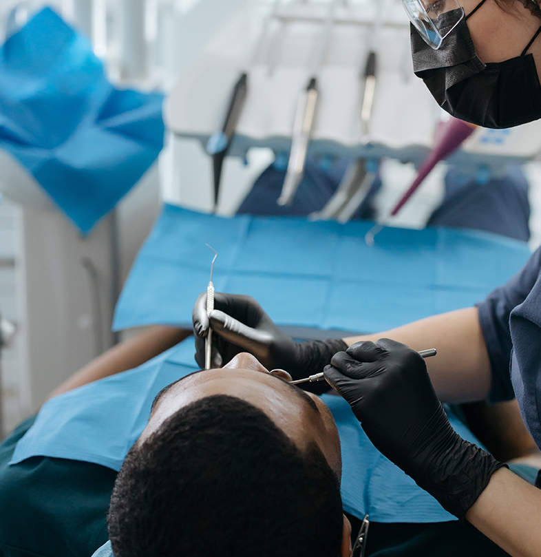 Dentist using professional tools during oral examination